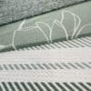 Three kitchen towels with different green designs