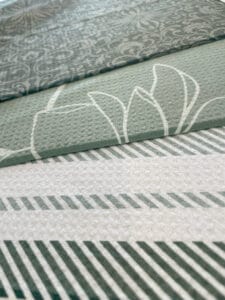 Three kitchen towels with different green designs