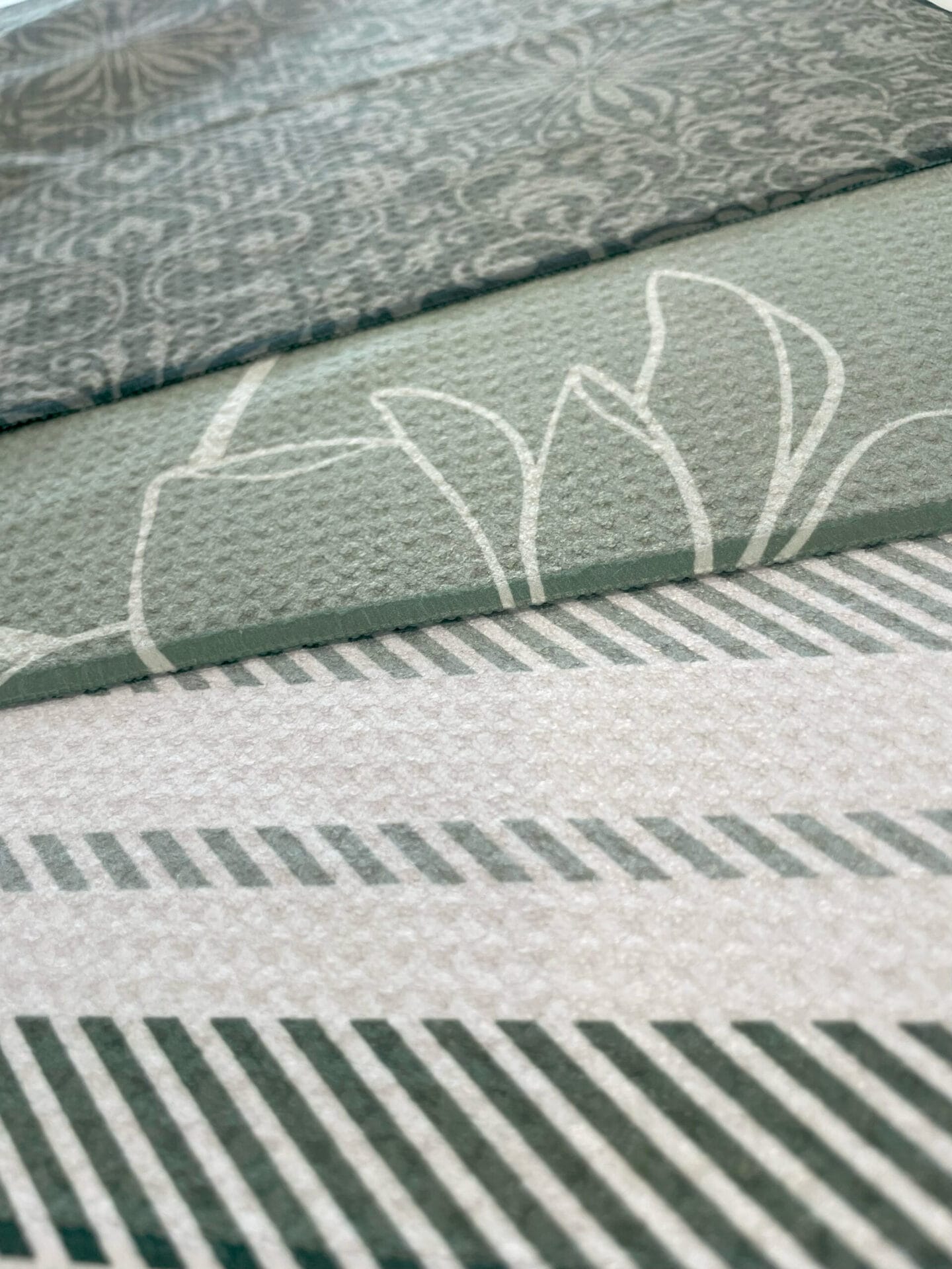 Three kitchen towels with different green designs